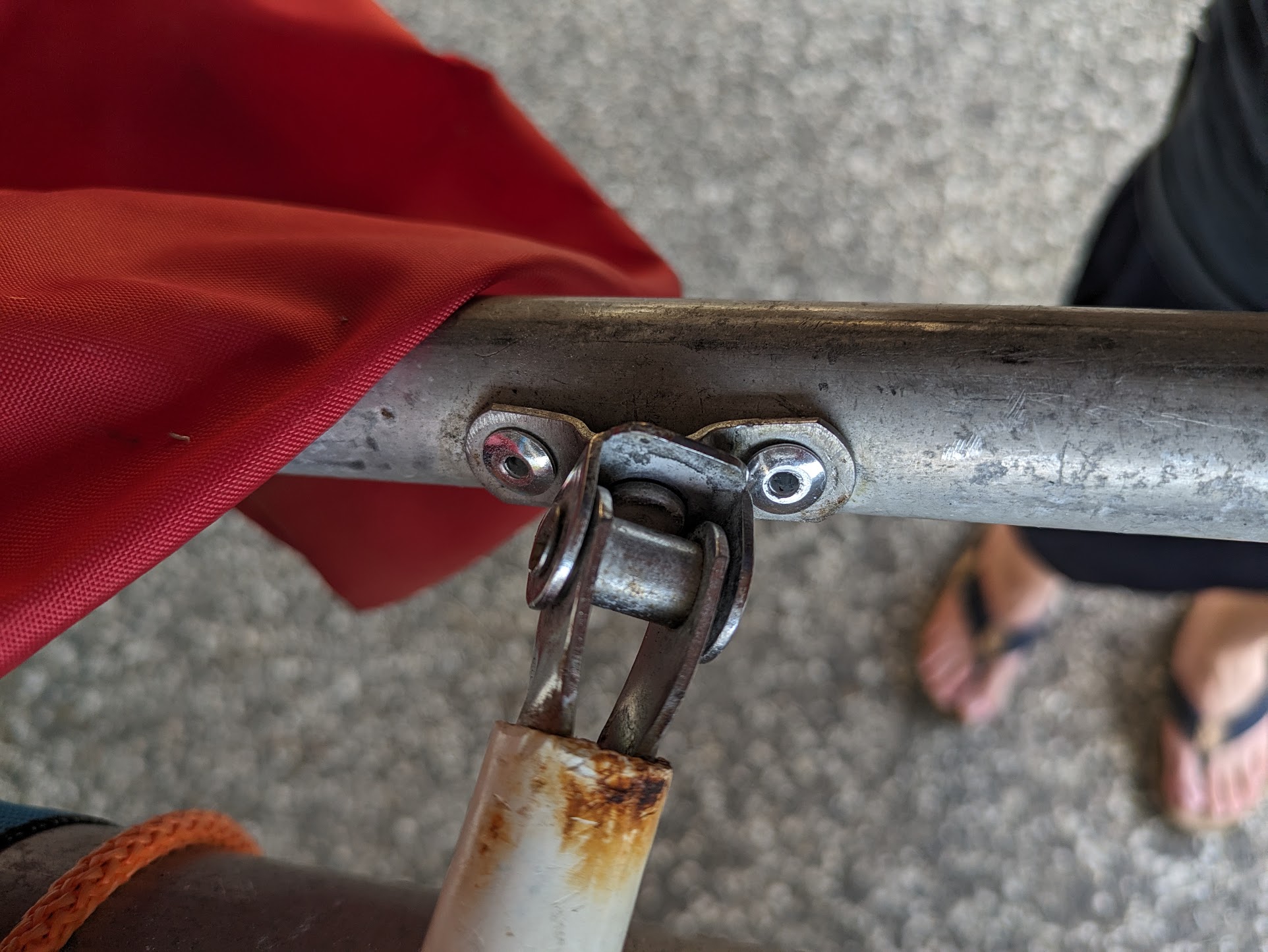 A photo of a join between white tiller handle and an aluminium bar. A photo of a join between white tiller handle and an aluminium bar.