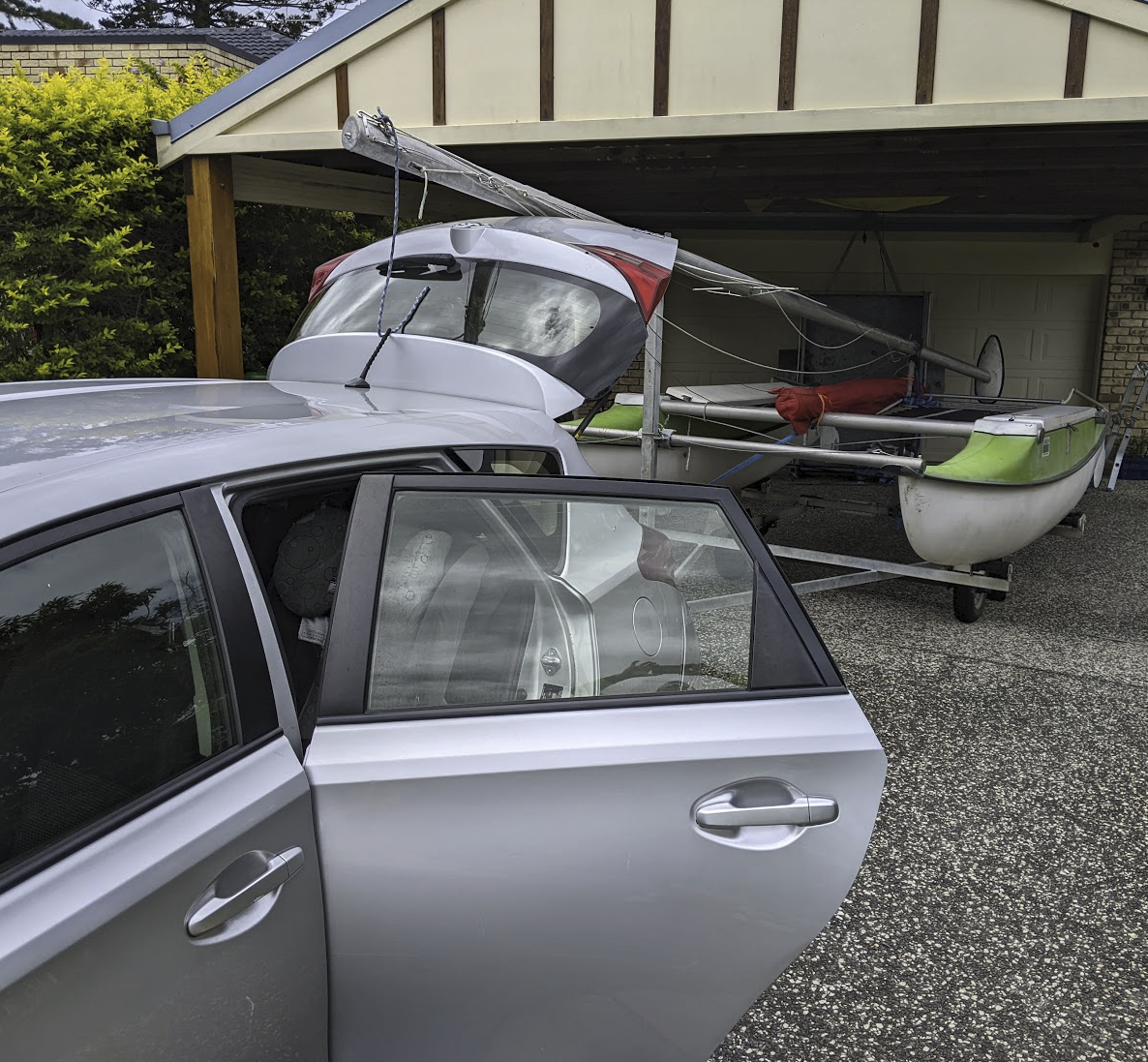 A photo of the boat on its trailer behind our silver corolla. A photo of the boat on its trailer behind our silver corolla.