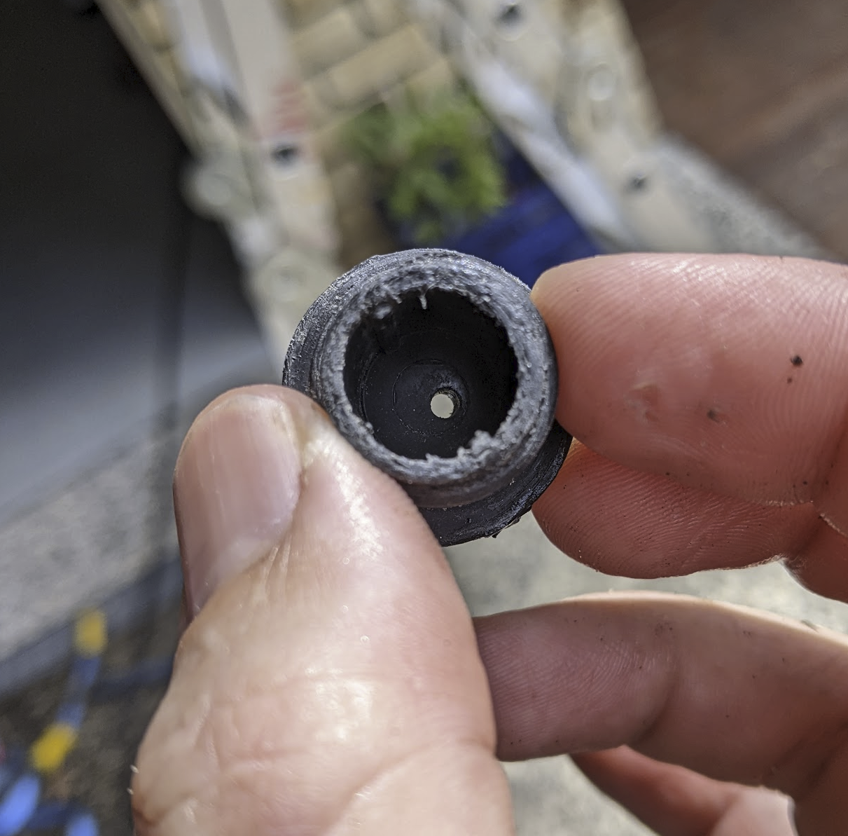 A photo of the bung showing a small hole drilled through it. A photo of the bung showing a small hole drilled through it.
