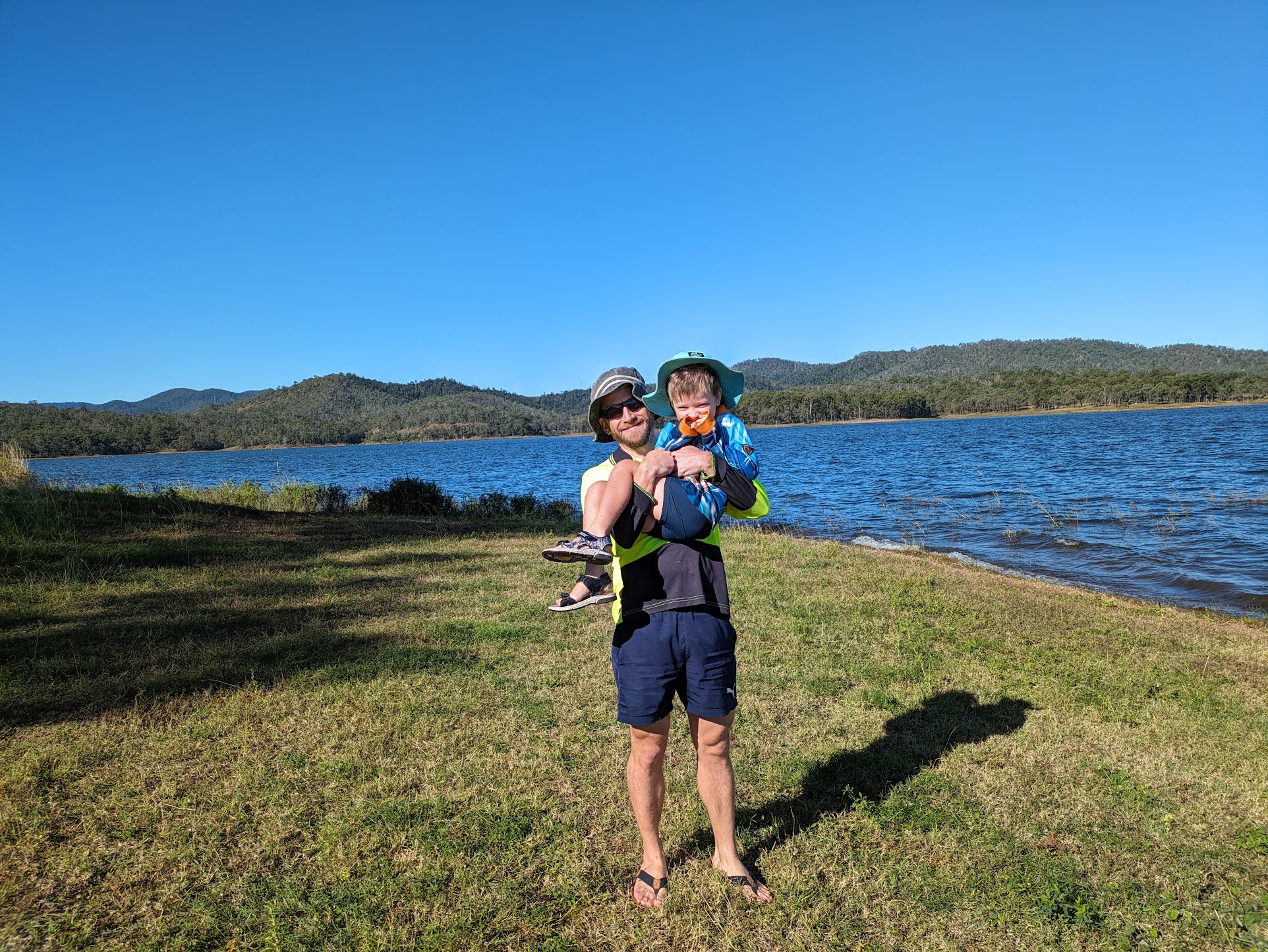 A photo of me holding Sam aloft on the shore.