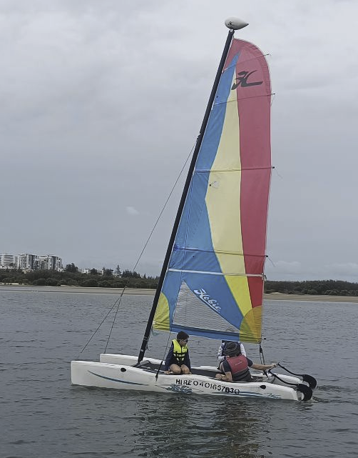 A photo of us four sailing a hobie catamaran.