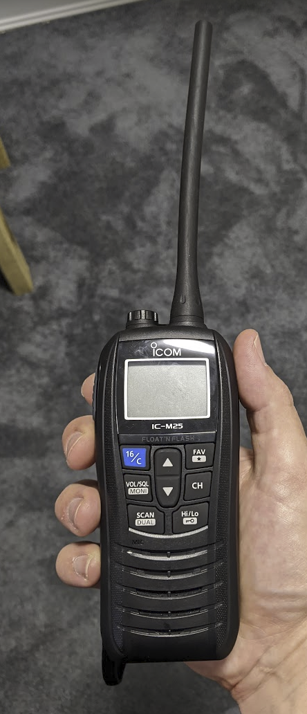 A photo of me holding an ICom IC-M25 radio.